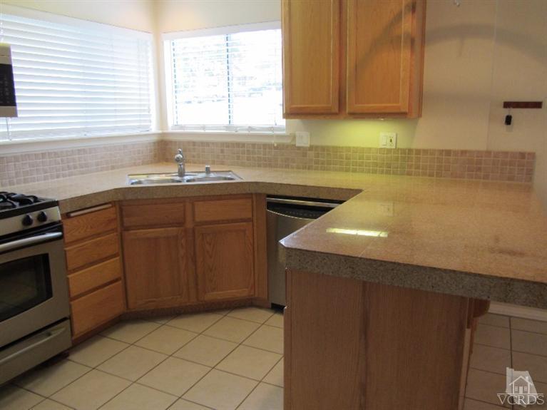 3192 Travis Avenue Simi Valley, CA 93063 - Photo 7 of 36 a kitchen with a sink cabinets and window