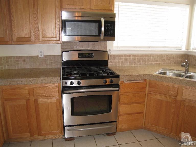 3192 Travis Avenue Simi Valley, CA 93063 - Photo 8 of 36 a kitchen with granite countertop cabinets stainless steel appliances and a sink