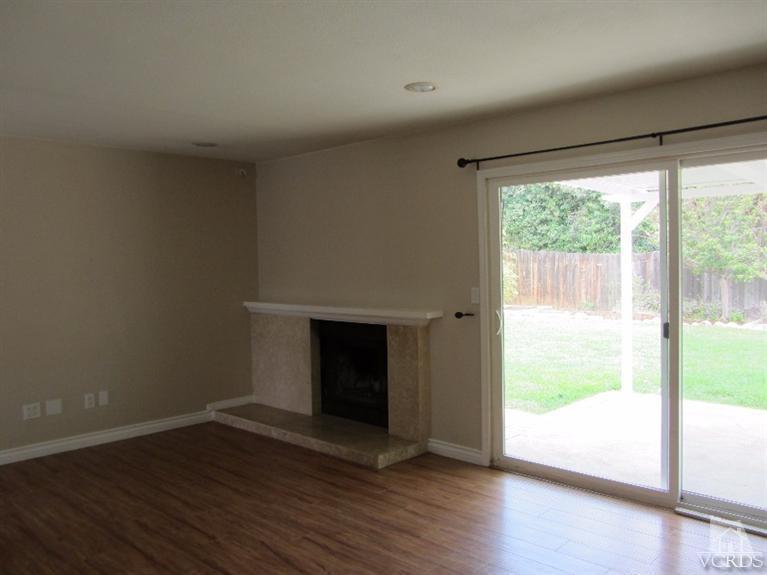 3192 Travis Avenue Simi Valley, CA 93063 - Photo 10 of 36 a view of empty room with wooden floor and fireplace