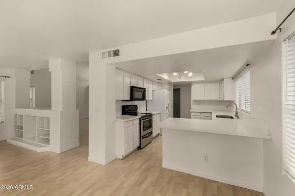 a large kitchen with cabinets and stainless steel appliances