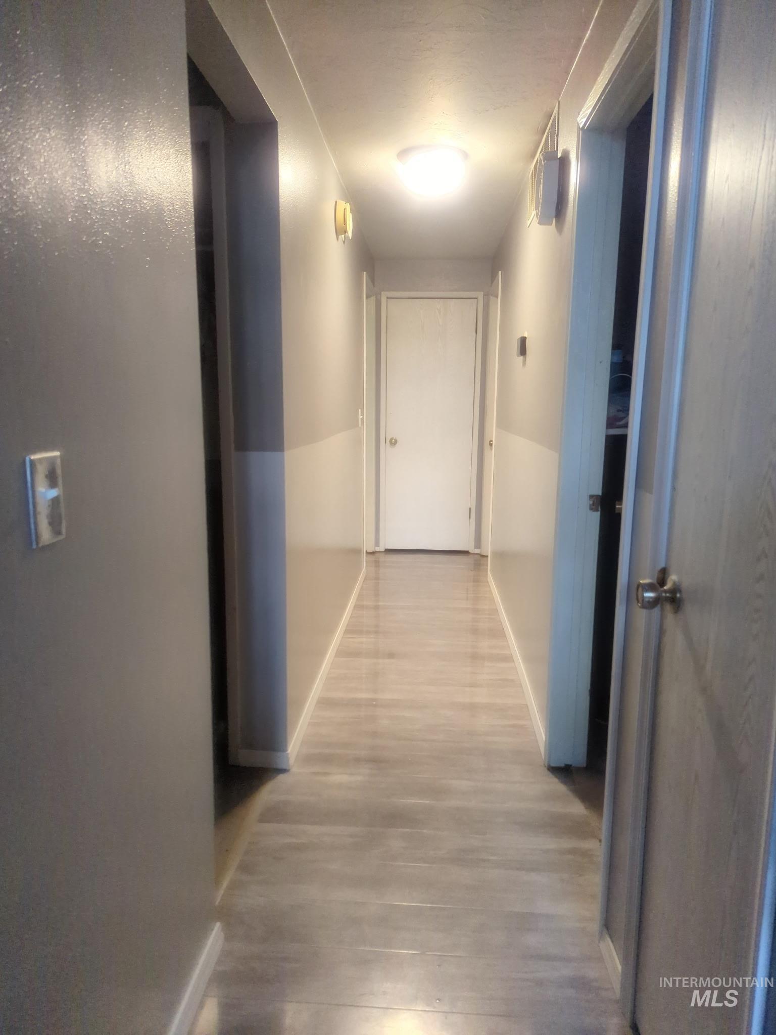 820 Meadows Drive Twin Falls, ID 83301 - Photo 12 of 23 Hallway with baseboards and light wood finished floors