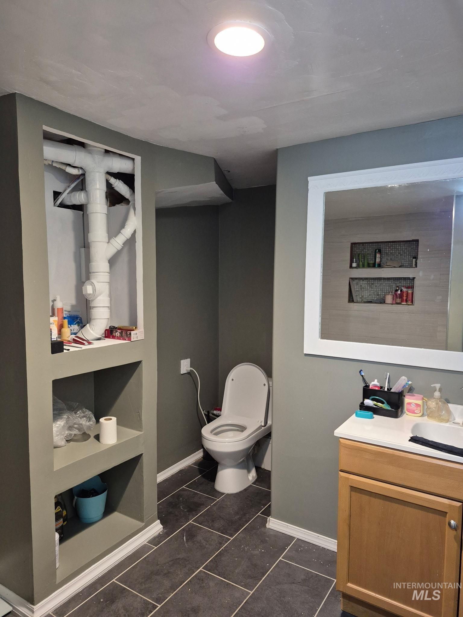 820 Meadows Drive Twin Falls, ID 83301 - Photo 14 of 18 Bathroom featuring vanity and dark tile patterned flooring