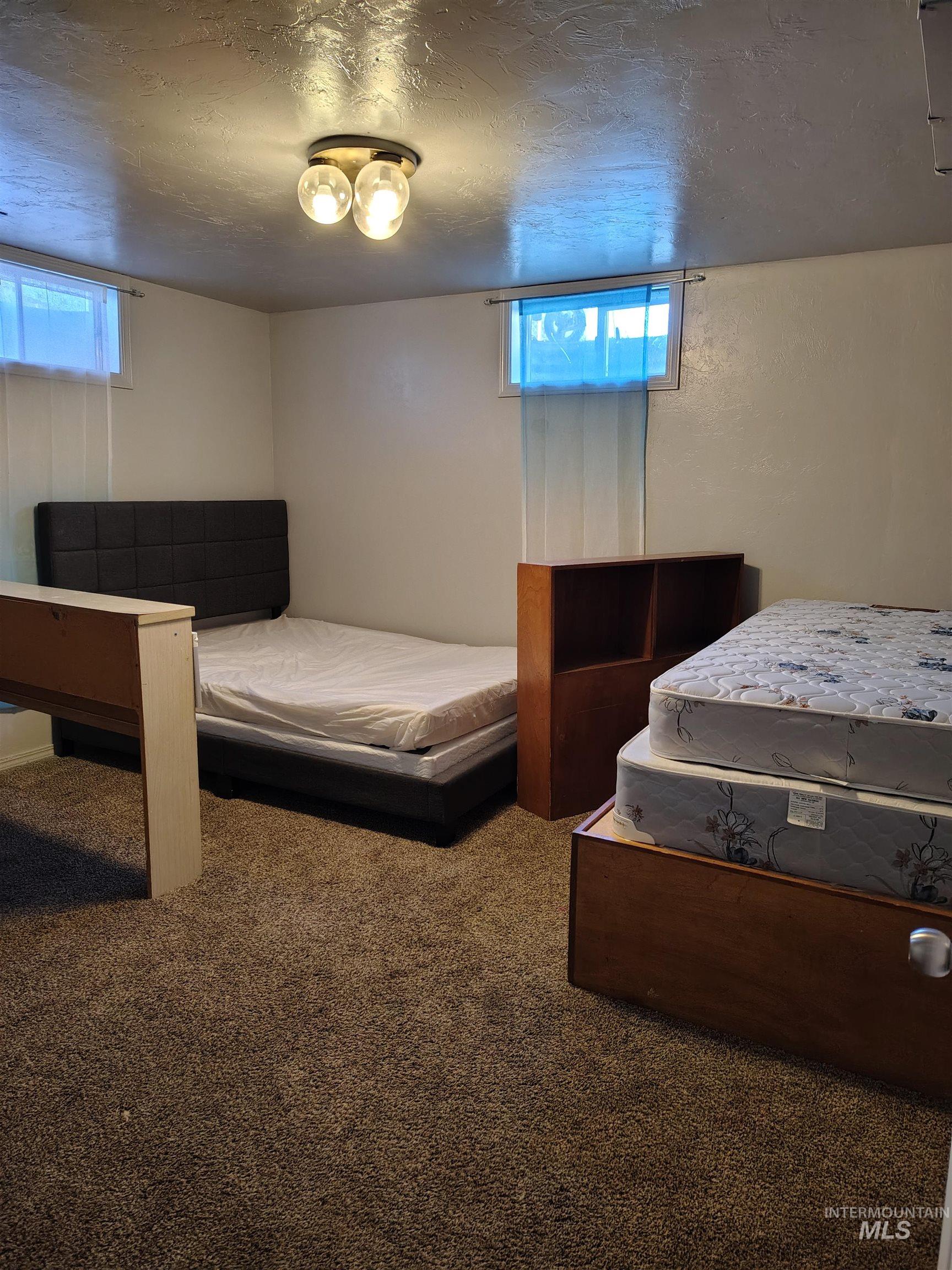 820 Meadows Drive Twin Falls, ID 83301 - Photo 15 of 18 Bedroom with carpet floors and a textured ceiling