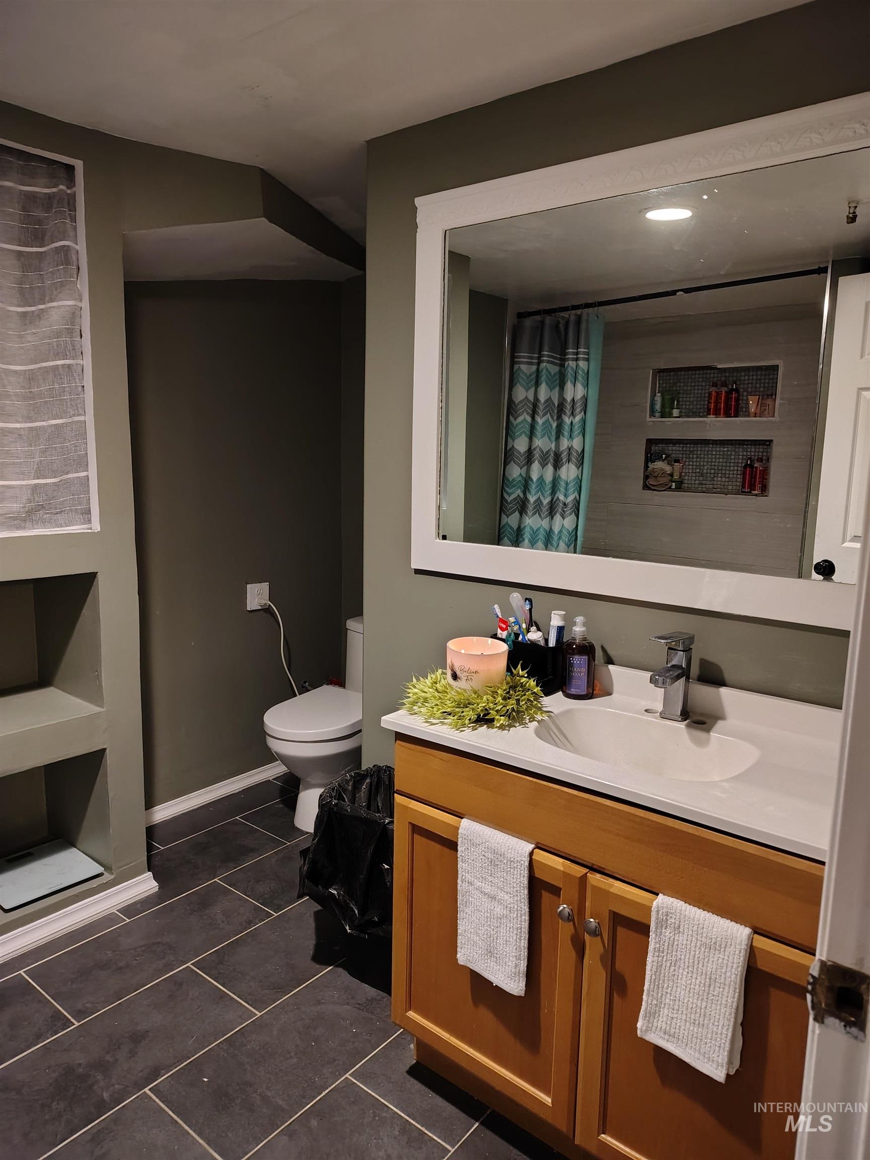 820 Meadows Drive Twin Falls, ID 83301 - Photo 16 of 23 Full bath featuring vanity, curtained shower, dark tile patterned flooring, and recessed lighting