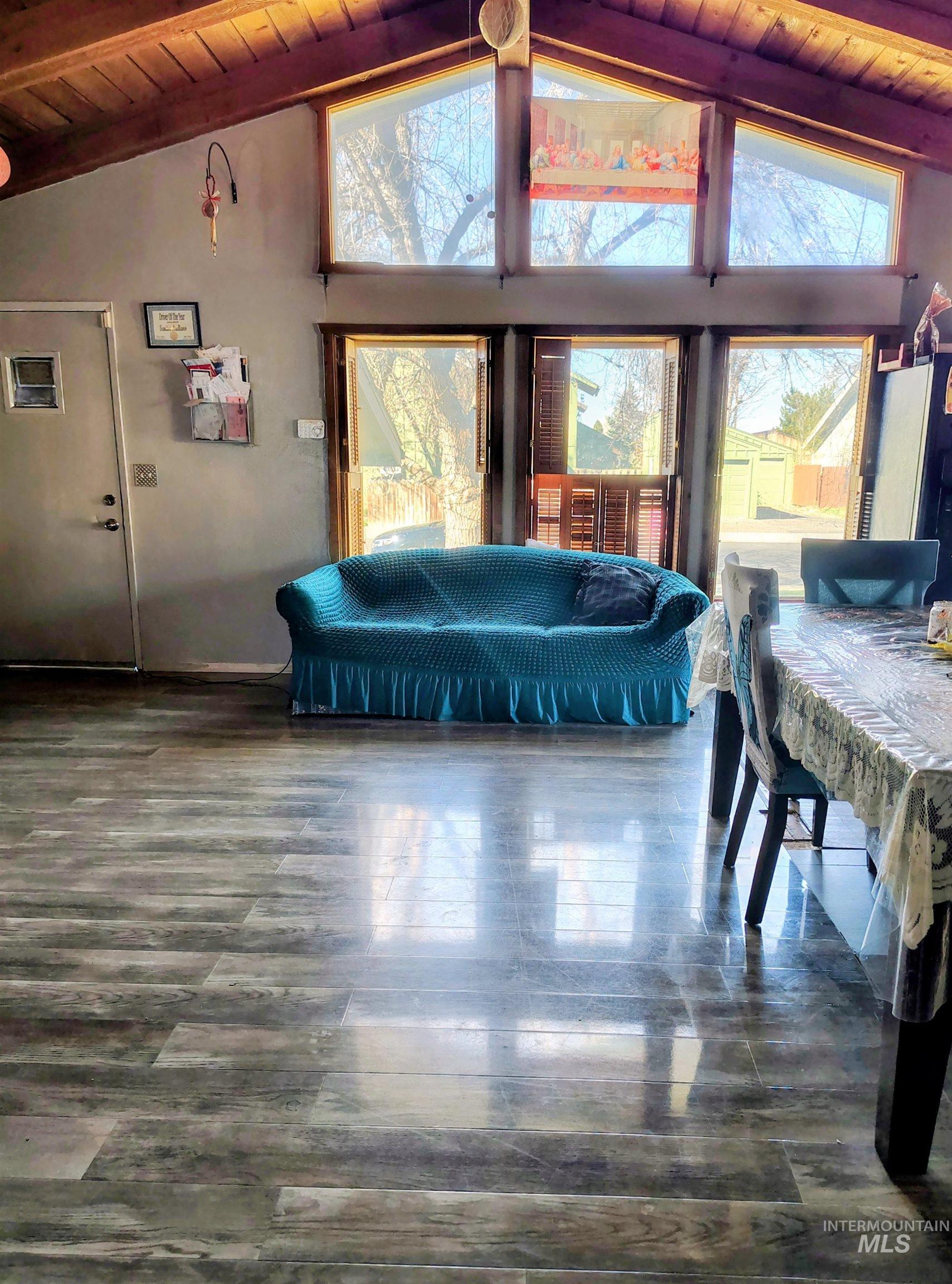 820 Meadows Drive Twin Falls, ID 83301 - Photo 3 of 18 Living room featuring a wood ceiling with exposed beams, plenty of natural light, and dark wood finished floors