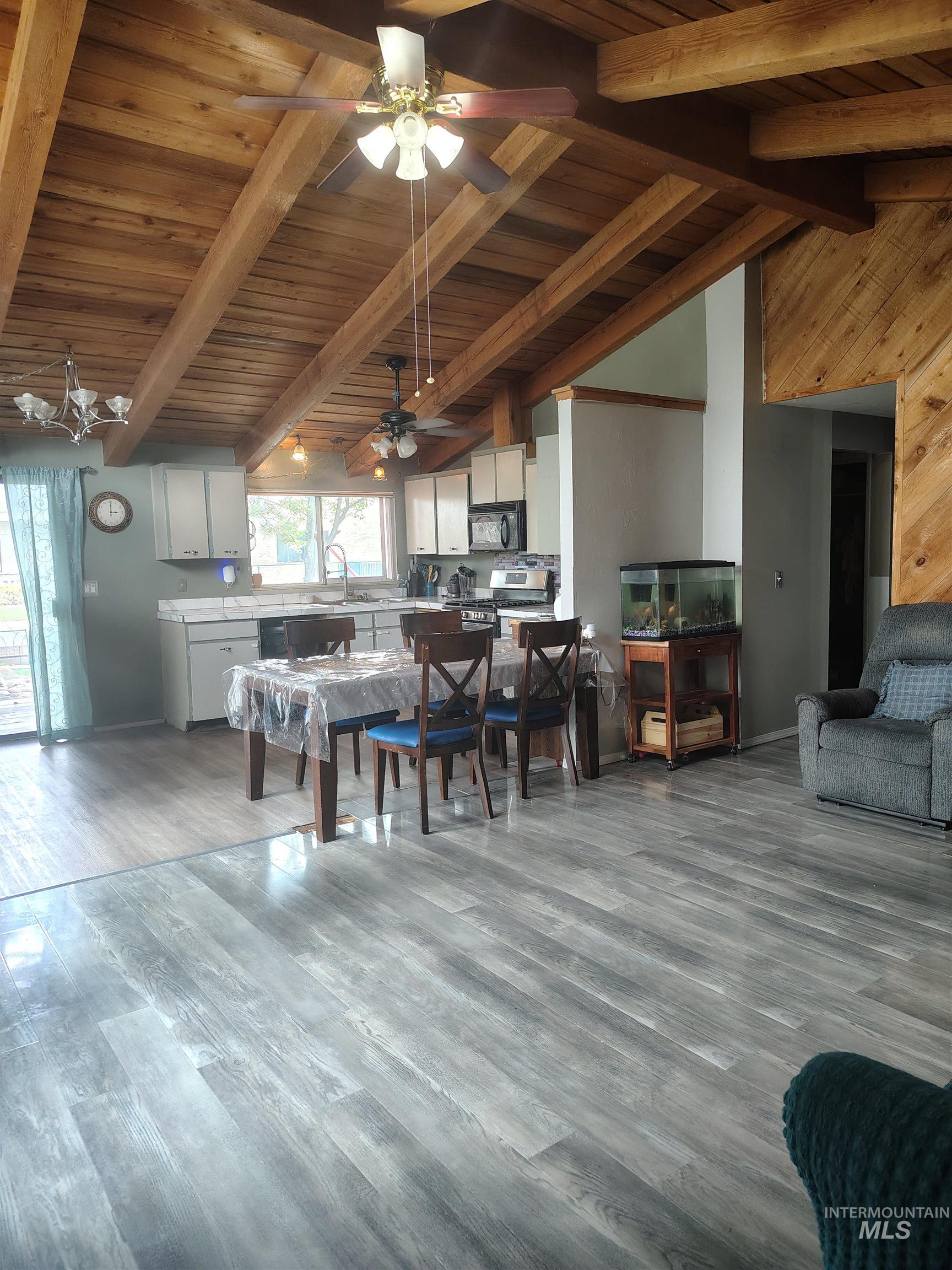 820 Meadows Drive Twin Falls, ID 83301 - Photo 4 of 23 Dining space featuring a high wooden beamed ceiling, light wood finished floors, and a ceiling fan
