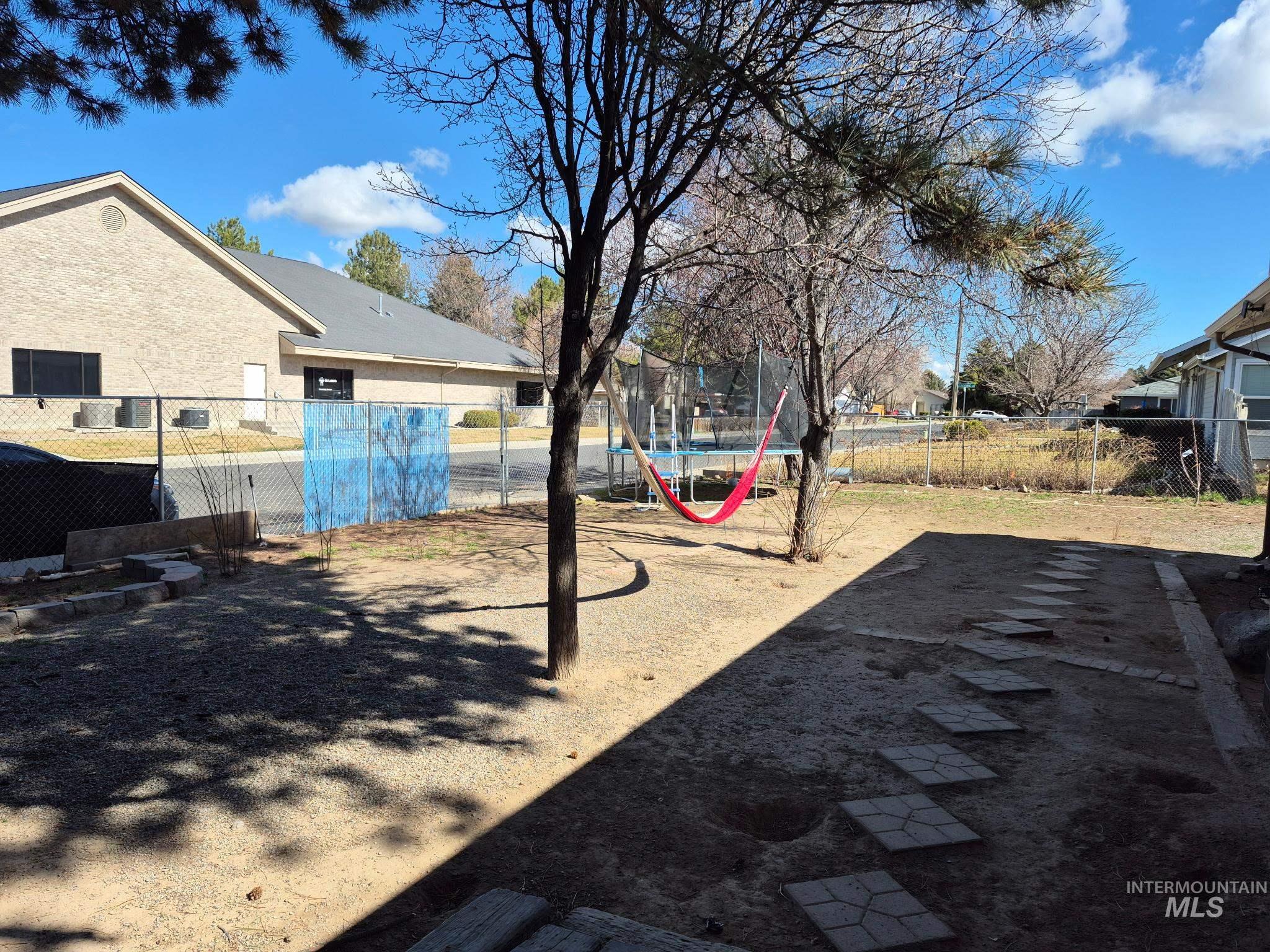 820 Meadows Drive Twin Falls, ID 83301 - Photo 5 of 18 Fenced backyard featuring a trampoline