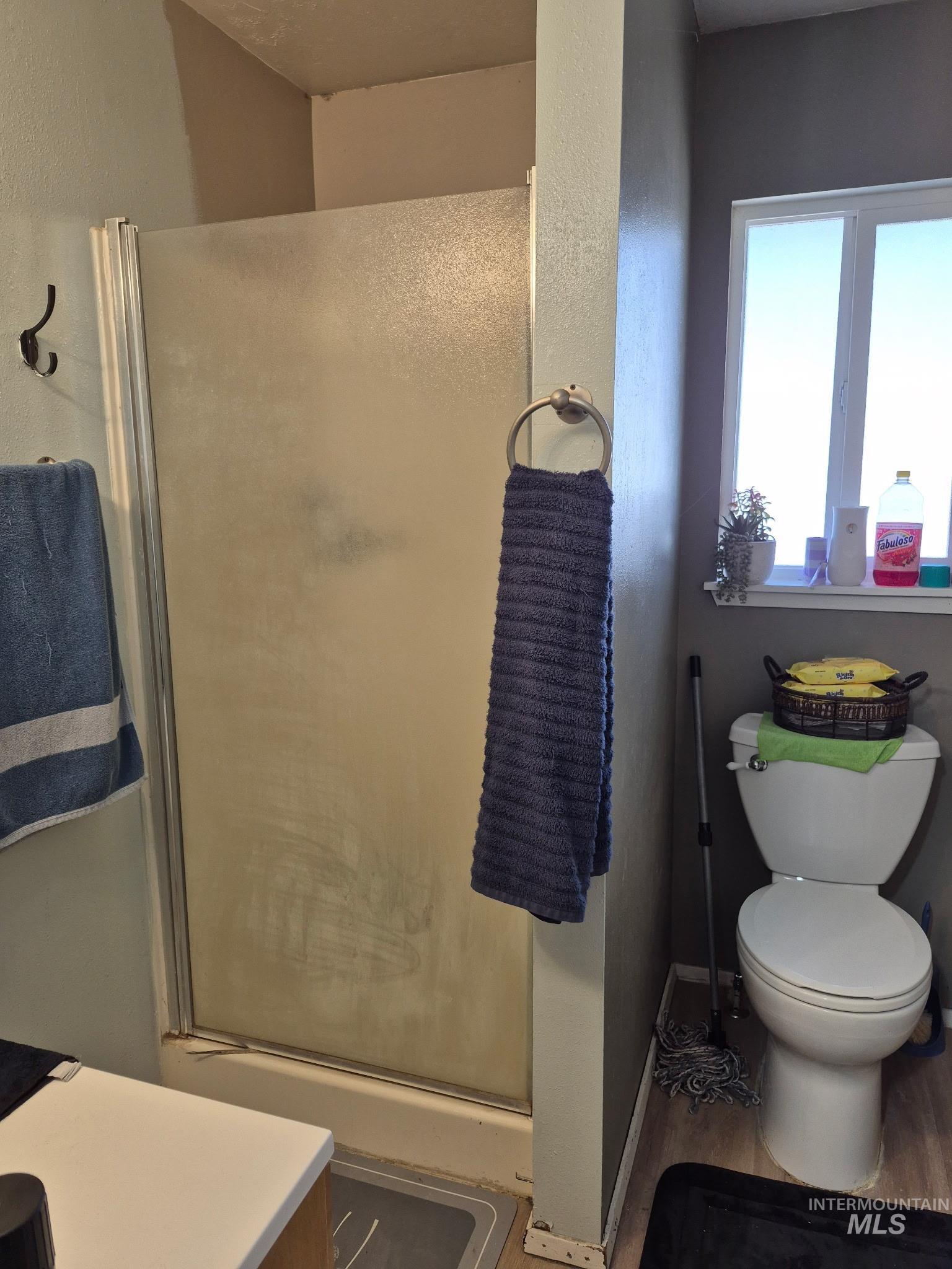 820 Meadows Drive Twin Falls, ID 83301 - Photo 7 of 18 Full bathroom featuring a shower stall, a textured wall, vanity, and wood finished floors