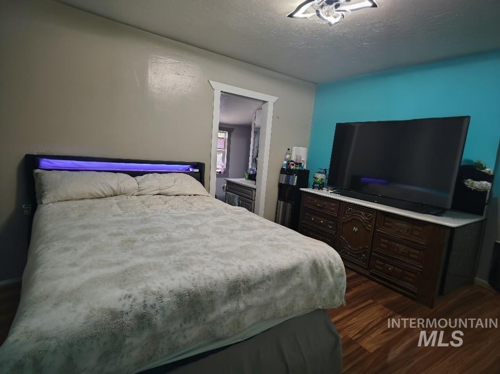 820 Meadows Drive Twin Falls, ID 83301 - Photo 7 of 23 Bedroom featuring a textured ceiling and dark wood-type flooring