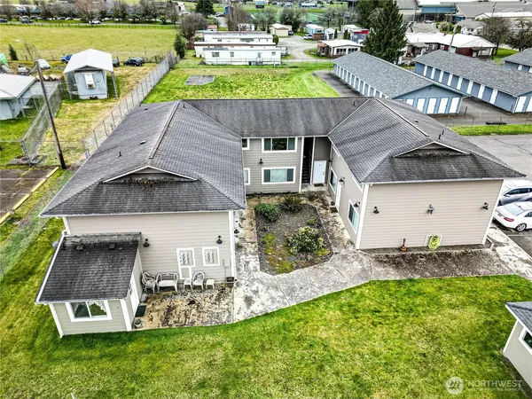 an aerial view of a house with swimming pool garden and patio