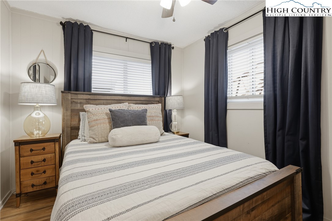 301 Pinnacle Inn Road, Unit 3301 Beech Mountain, NC 28604 - Photo 11 of 34 a bedroom with a bed and wooden floor