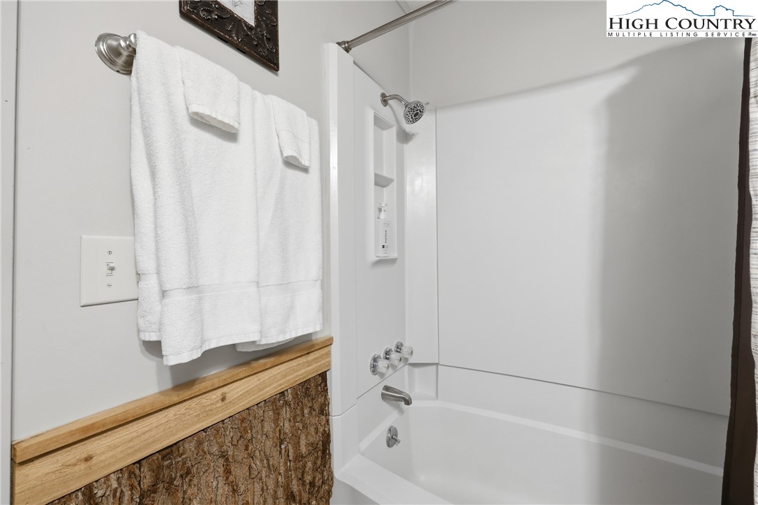 301 Pinnacle Inn Road, Unit 3301 Beech Mountain, NC 28604 - Photo 18 of 34 a bathroom with a bathtub and shower