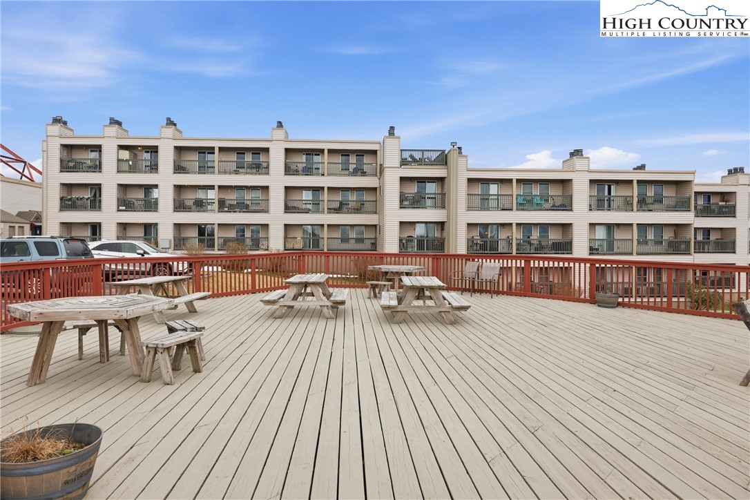 301 Pinnacle Inn Road, Unit 3301 Beech Mountain, NC 28604 - Photo 23 of 34 a view of a roof deck with table and chairs and wooden floor
