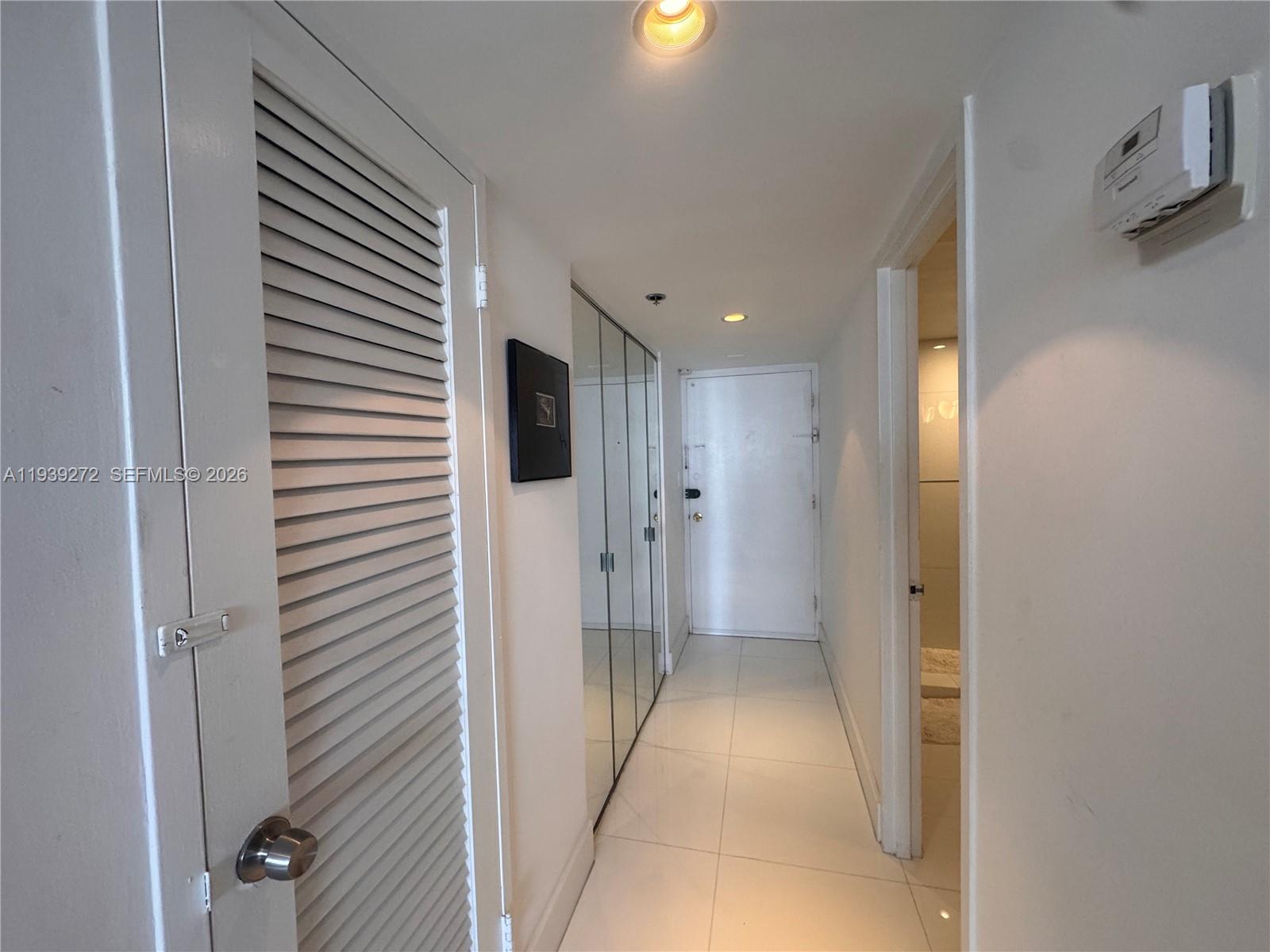 100 Lincoln Road, Unit 1230 Miami Beach, FL 33139 - Photo 12 of 38 a view of a hallway with wooden shelves