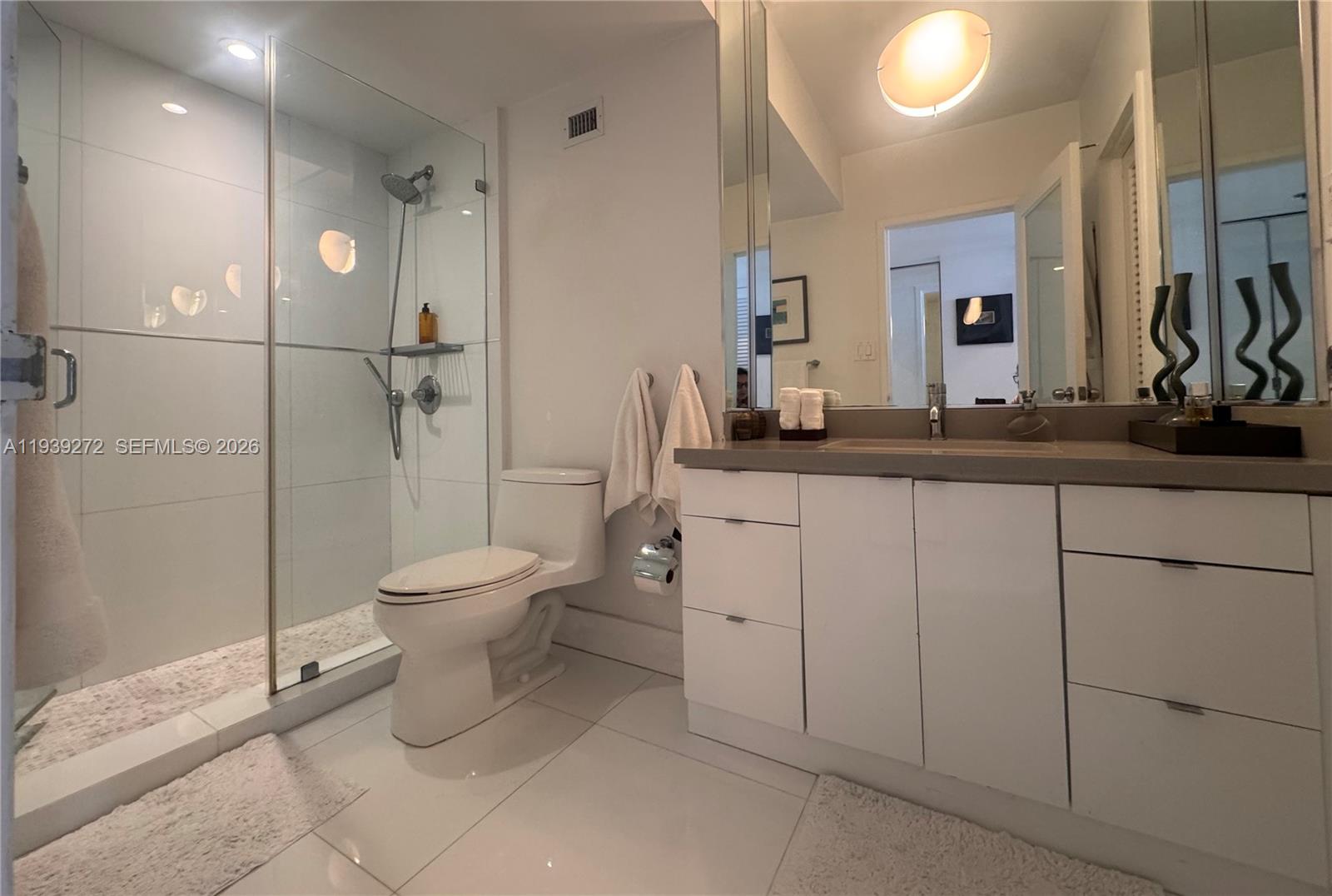 100 Lincoln Road, Unit 1230 Miami Beach, FL 33139 - Photo 13 of 38 a bathroom with a toilet sink and shower