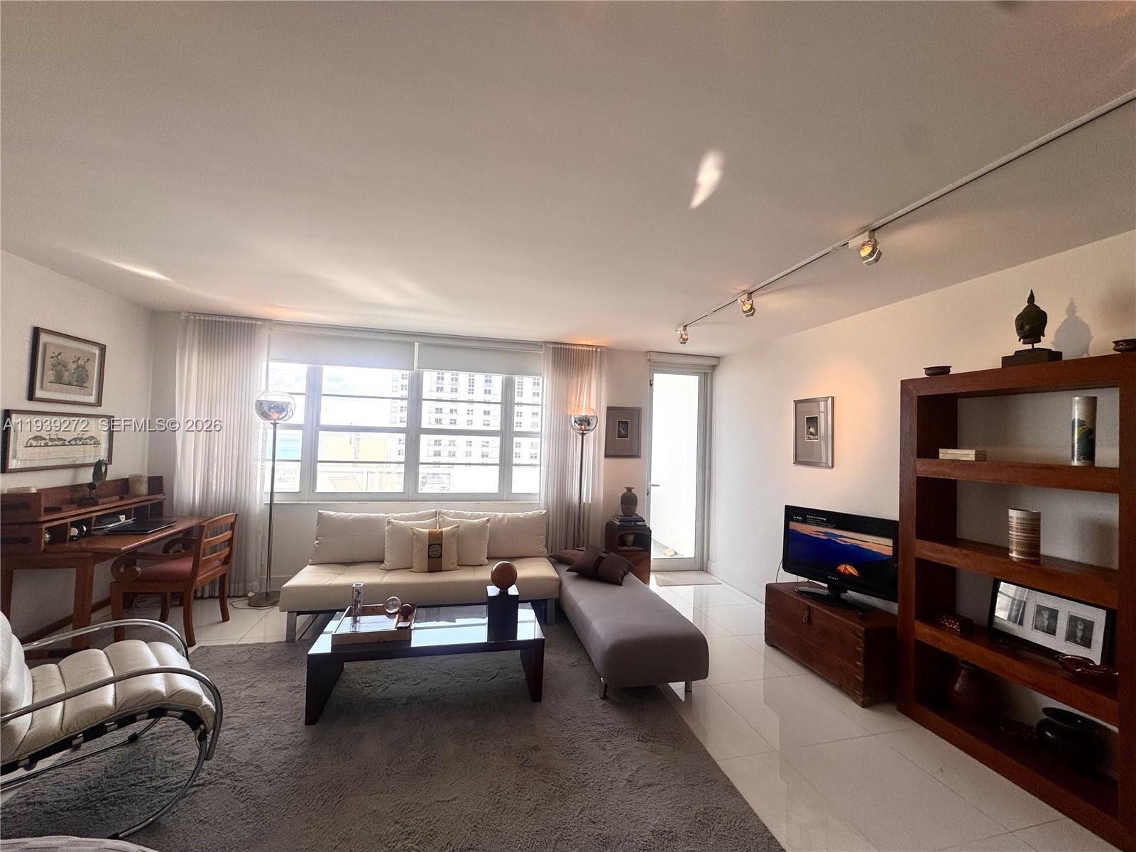 100 Lincoln Road, Unit 1230 Miami Beach, FL 33139 - Photo 14 of 38 a living room with furniture and a flat screen tv