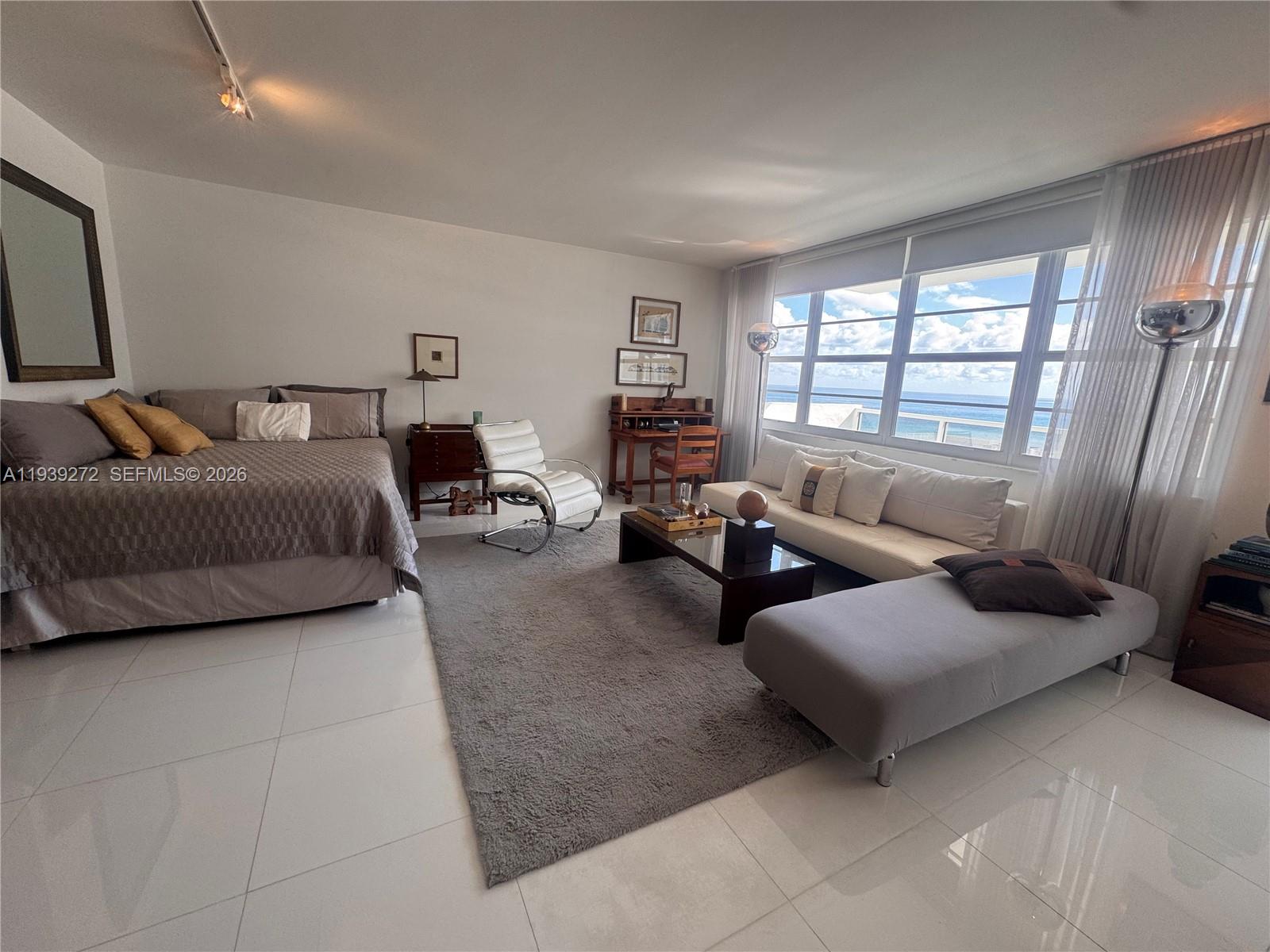 100 Lincoln Road, Unit 1230 Miami Beach, FL 33139 - Photo 9 of 38 a bedroom with furniture and a large window