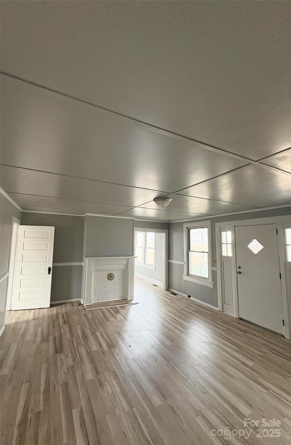 8 Maple Street Great Falls, SC 29055 - Photo 3 of 15 an empty room with wooden floor and windows
