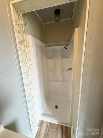 a bathroom with a glass door shower