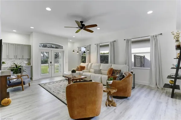 a living room with furniture and a wooden floor