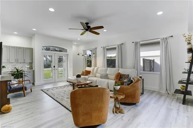 a living room with furniture and a wooden floor