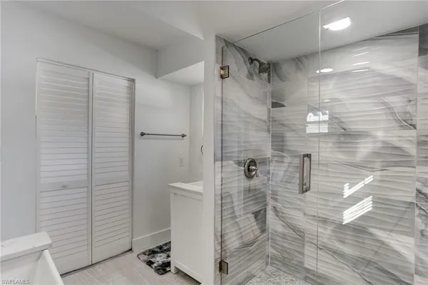 a bathroom with a shower and a sink
