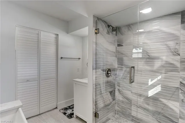 a bathroom with a shower and a sink