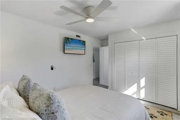 a bedroom with a bed and a painting on the wall
