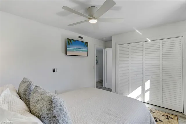 a bedroom with a bed and a painting on the wall