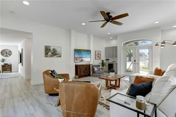 a living room with furniture ceiling fan and a window