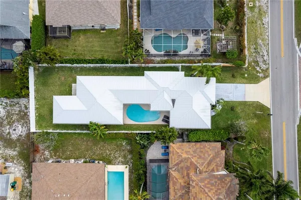 an aerial view of a house with a garden and lake view
