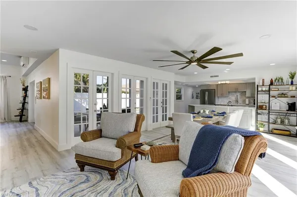 a living room with furniture and a ceiling fan