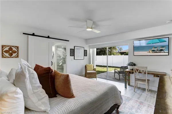 a bedroom with a bed a table and chair