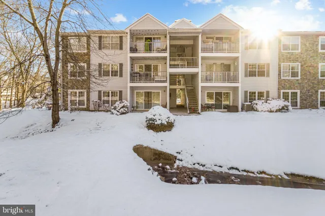 a front view of a building with parking space