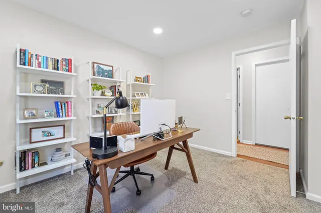 a workspace with furniture and a book shelf