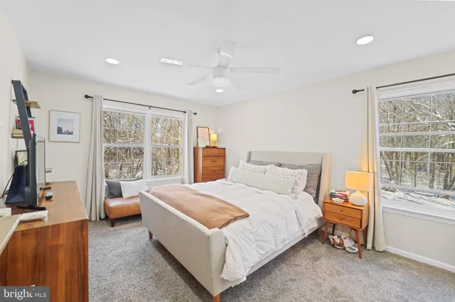 a bed room with a bed and a large window