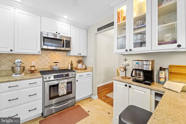 a kitchen with stainless steel appliances granite countertop a stove and a sink