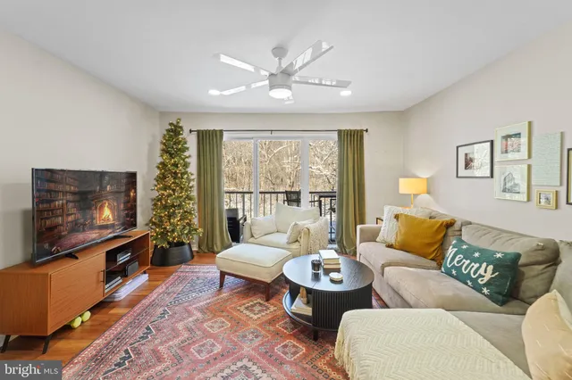 a living room with furniture a rug and a flat screen tv