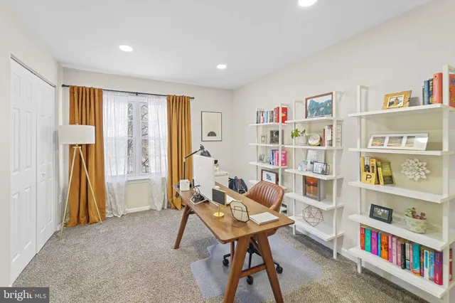 a living room with furniture and a book shelf