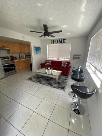 a living room with furniture and kitchen view