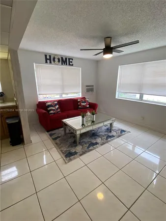 a living room with granite countertop furniture a rug and a window