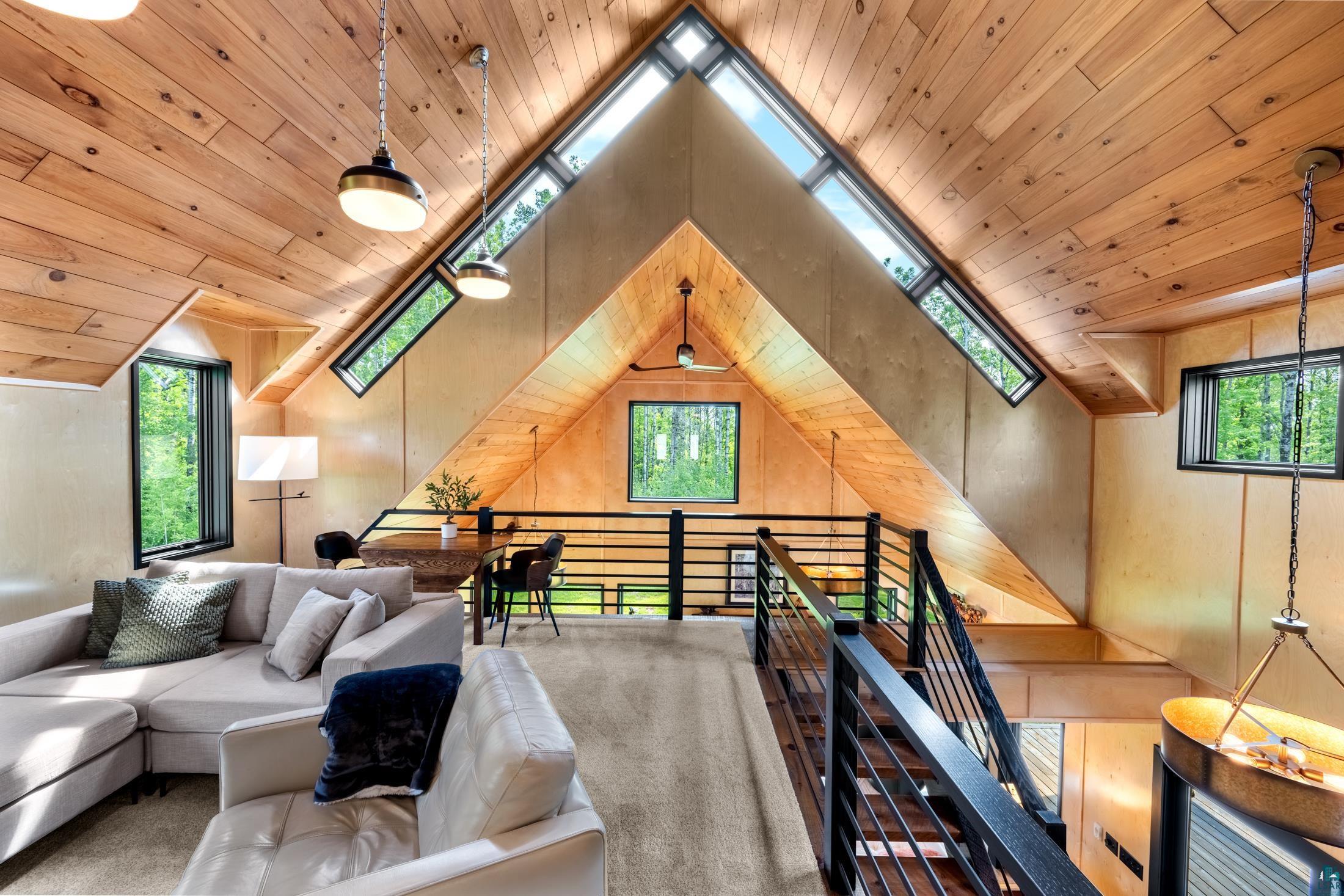 3778 East County Road Barnum, MN 55707 - Photo 37 of 52 Vaulted wood-paneled ceilings, multi-level design, and black metal railings
