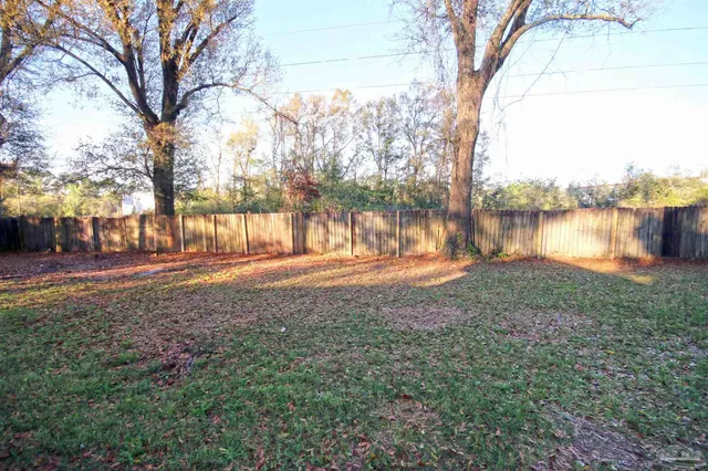 a backyard of a house with lots of green space