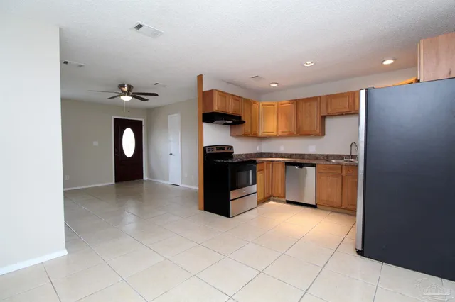 a kitchen with stainless steel appliances granite countertop a stove and a refrigerator