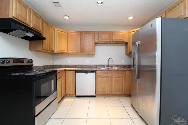 a kitchen with a sink a stove and refrigerator