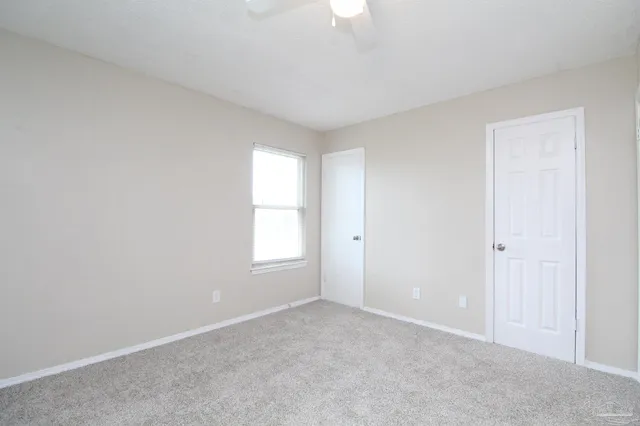 a view of an empty room with a window