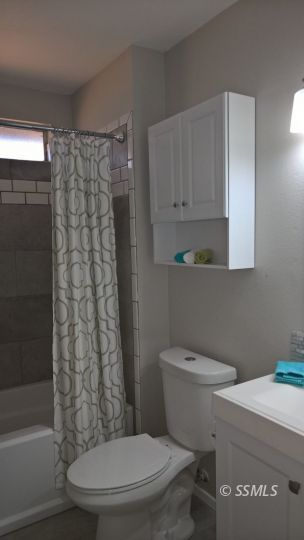 700 Commercial Avenue Ridgecrest, CA 93555 - Photo 10 of 10 a white toilet sitting next to a bathroom sink