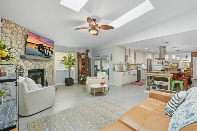 a living room with furniture a fireplace and a flat screen tv