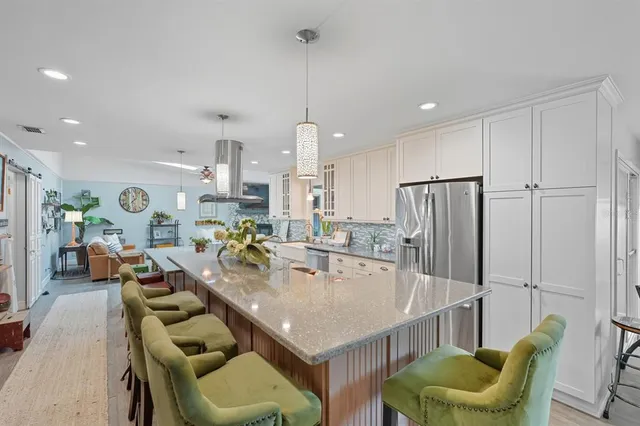 a large kitchen with a table chairs and a living room