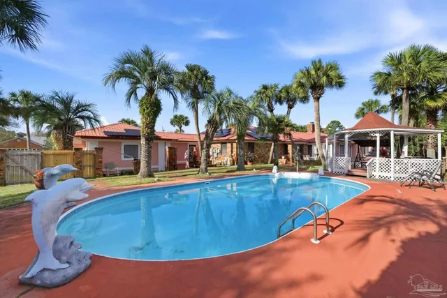 a view of a swimming pool with chair and tables